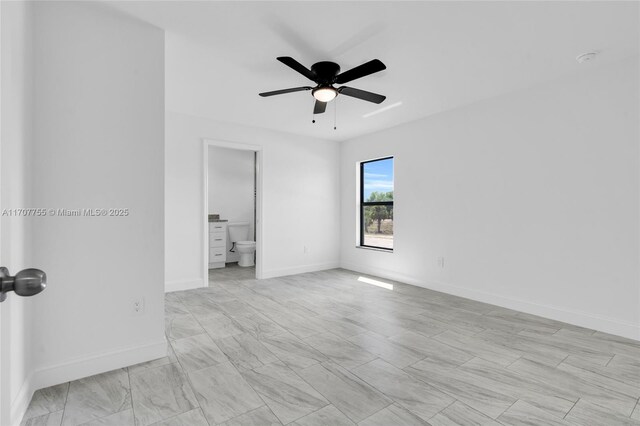 unfurnished room with baseboards and a ceiling fan