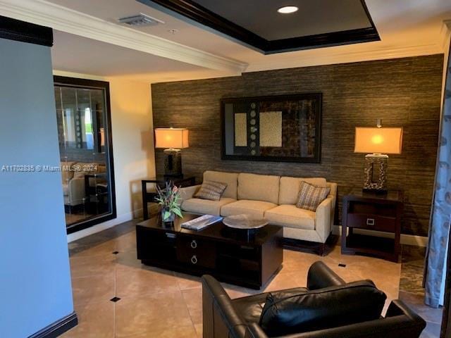 living room with light tile patterned floors and ornamental molding