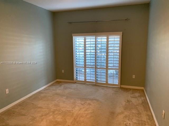 unfurnished room with light carpet