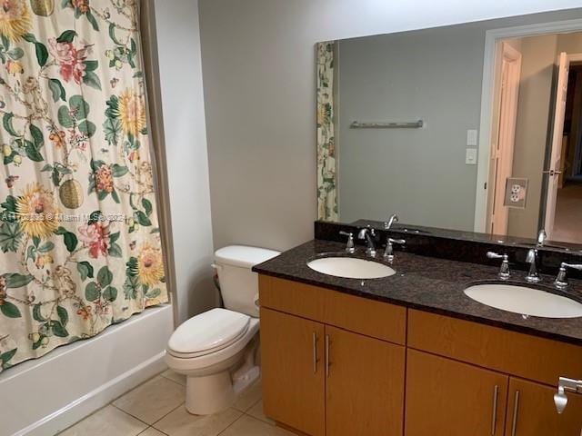 full bathroom with tile patterned flooring, vanity, toilet, and shower / bath combo with shower curtain