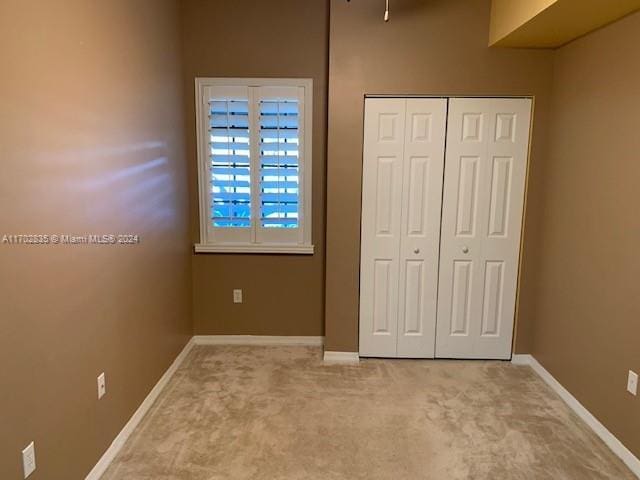 unfurnished bedroom featuring a closet and carpet