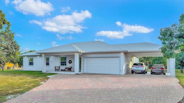 ranch-style house featuring a carport, a garage, and a front lawn