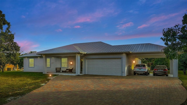 ranch-style home with a lawn and a carport