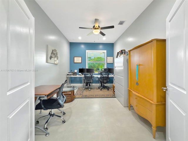 tiled home office featuring ceiling fan