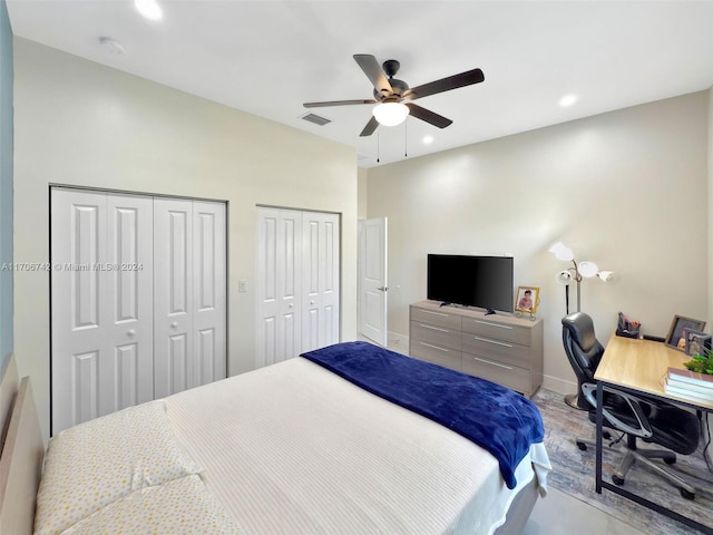 bedroom featuring ceiling fan and two closets