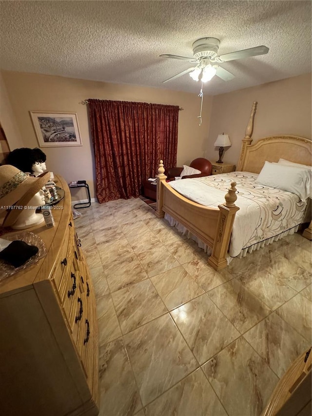 bedroom with ceiling fan and a textured ceiling