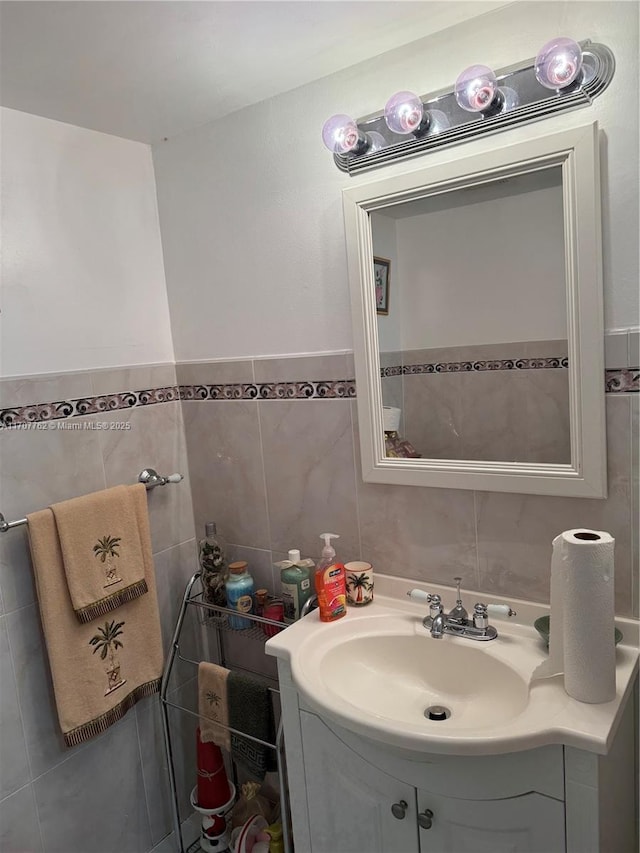 bathroom with tile walls and vanity