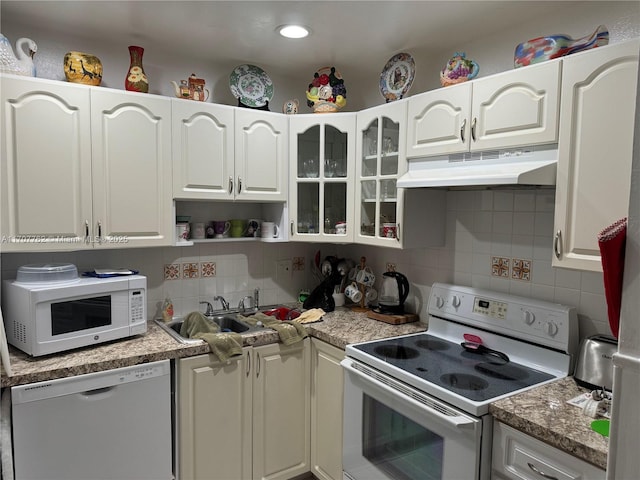 kitchen with sink, backsplash, white cabinets, and white appliances