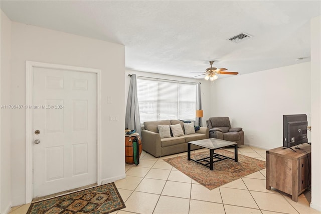 living room featuring ceiling fan and light tile patterned flooring