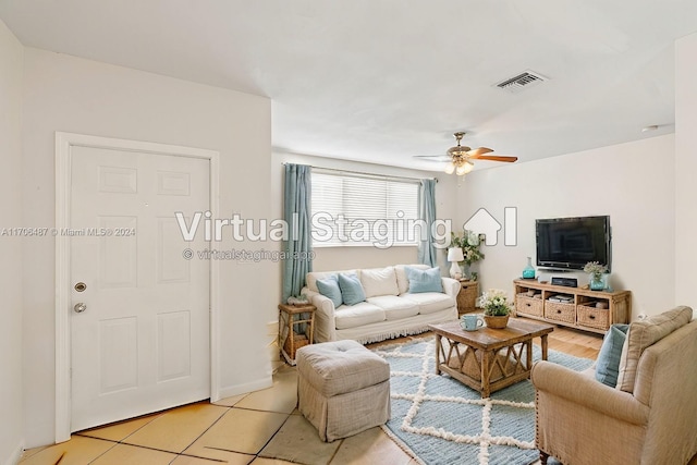 living room featuring ceiling fan and light tile patterned floors