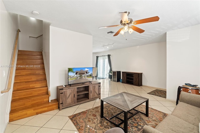 tiled living room with ceiling fan