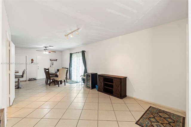 tiled dining space featuring ceiling fan and track lighting