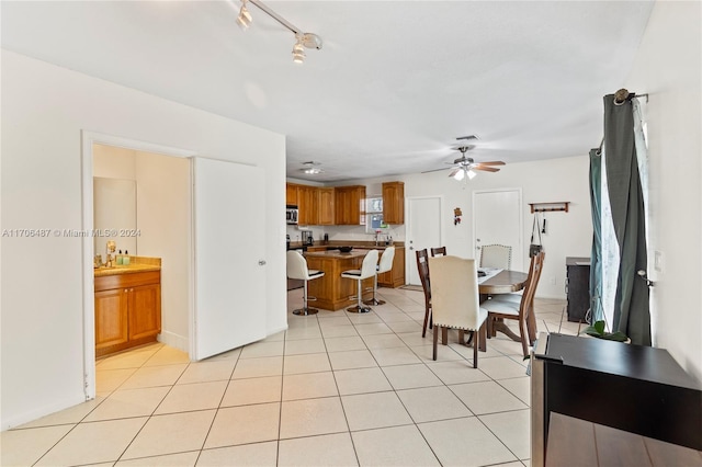 dining area featuring light tile patterned floors and ceiling fan