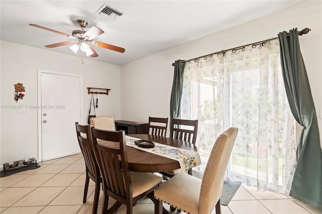 tiled dining space with ceiling fan