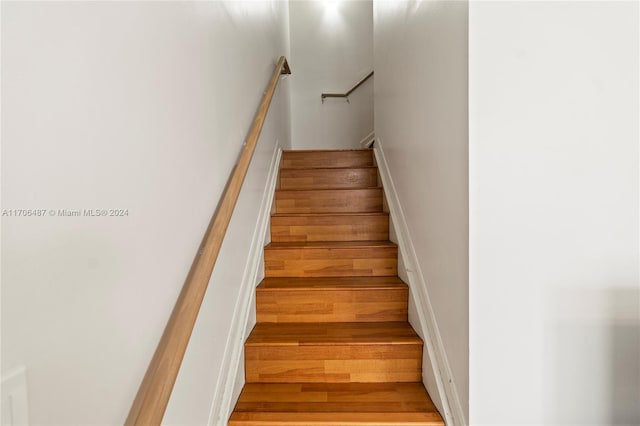 stairs featuring hardwood / wood-style flooring