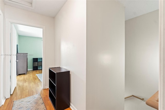 corridor with hardwood / wood-style floors