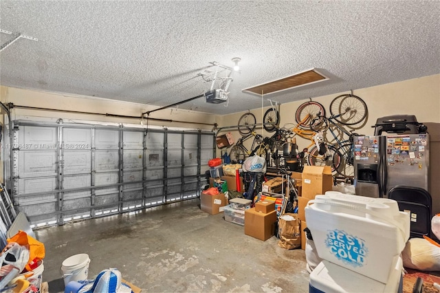 garage with a garage door opener and stainless steel refrigerator with ice dispenser