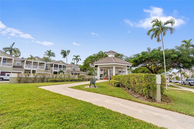 view of property's community with a gazebo and a lawn