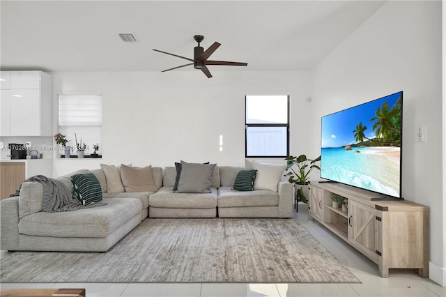 living room with ceiling fan and light tile patterned flooring