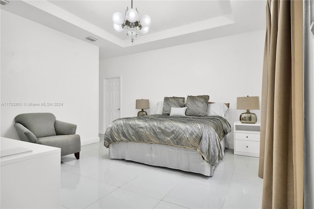 tiled bedroom featuring a raised ceiling and a notable chandelier