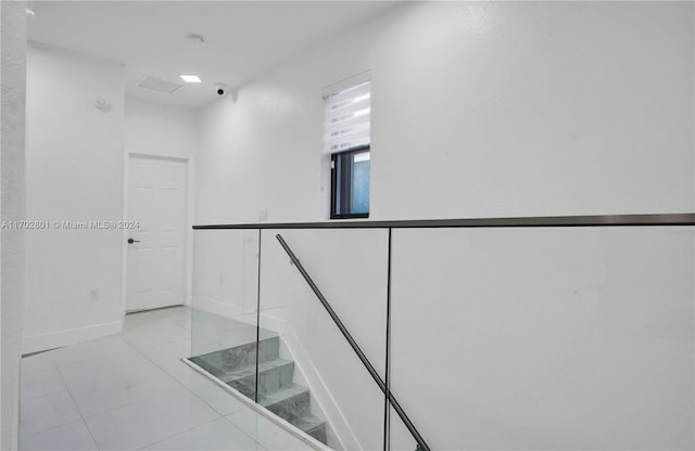 stairway featuring tile patterned floors