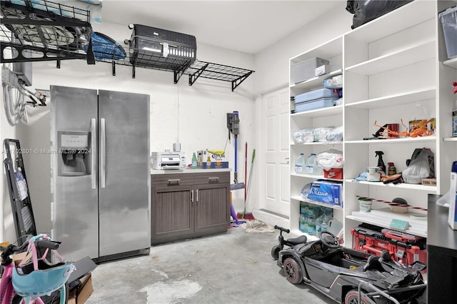 interior space with stainless steel refrigerator with ice dispenser and dark brown cabinets