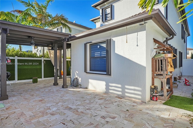 exterior space featuring ceiling fan and a patio area