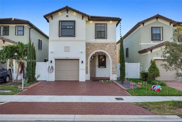 mediterranean / spanish house with a garage