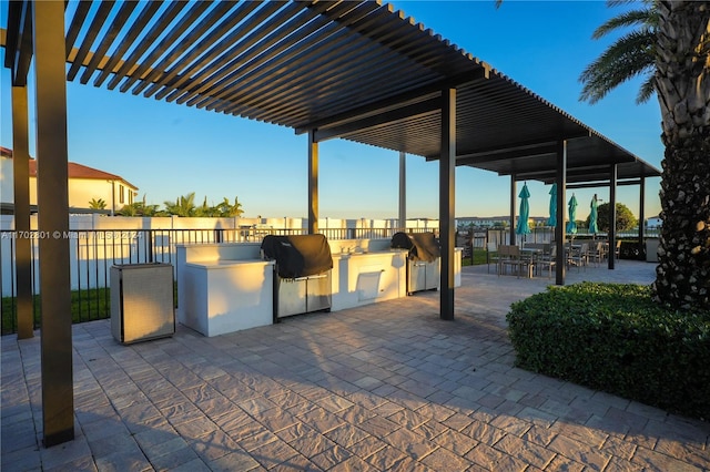 view of patio featuring a grill, area for grilling, and a pergola