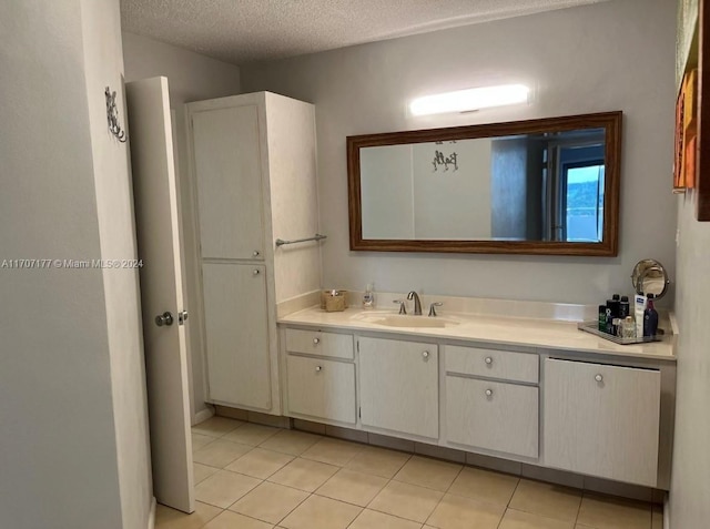 bathroom featuring vanity, a textured ceiling, and tile patterned flooring