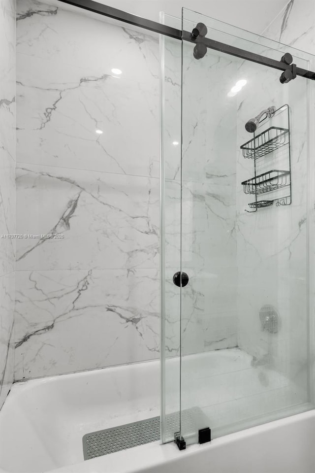 bathroom featuring bath / shower combo with glass door