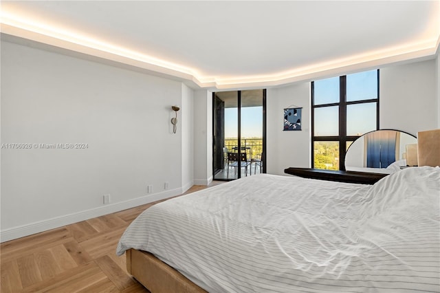 bedroom featuring parquet floors and access to outside