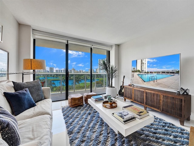 living room featuring tile patterned floors, plenty of natural light, and expansive windows