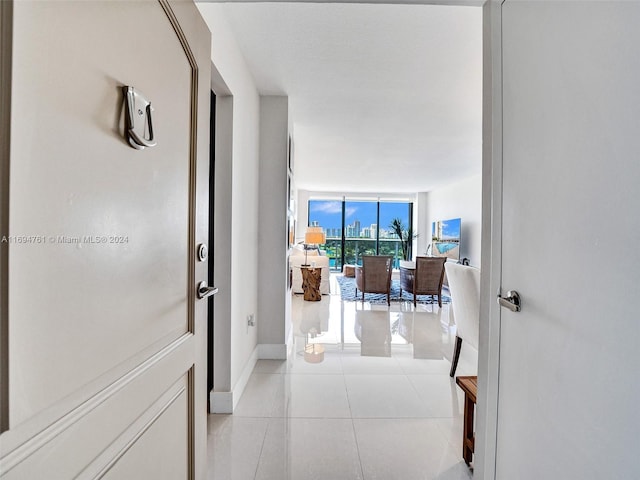 corridor featuring light tile patterned floors and expansive windows