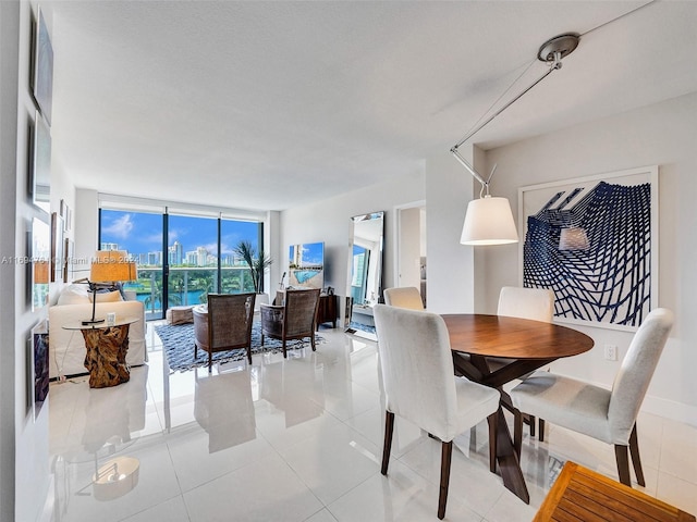 tiled dining space featuring floor to ceiling windows