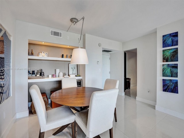 dining area featuring light tile patterned floors