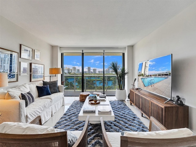 living room featuring expansive windows and a textured ceiling