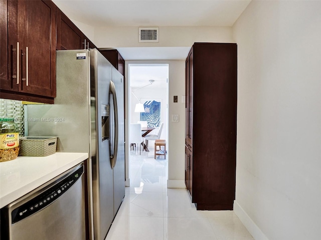 kitchen featuring dishwasher and light tile patterned floors