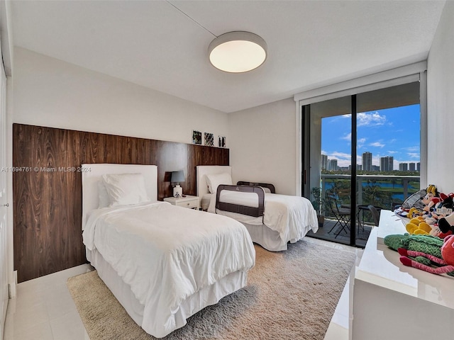 bedroom with expansive windows and access to exterior