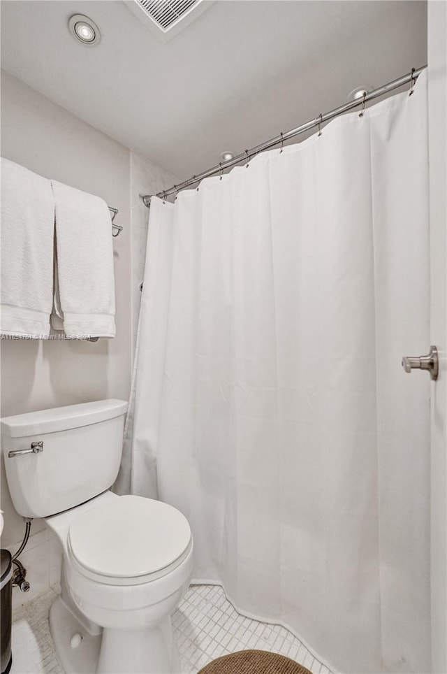 bathroom featuring tile patterned floors and toilet