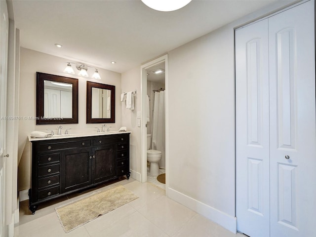 bathroom with tile patterned floors, curtained shower, vanity, and toilet