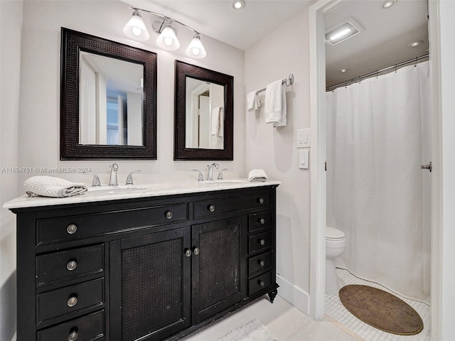 bathroom featuring toilet, vanity, and tile patterned floors