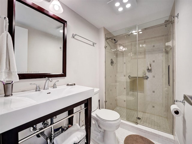 bathroom featuring tile patterned flooring, toilet, and a shower with shower door