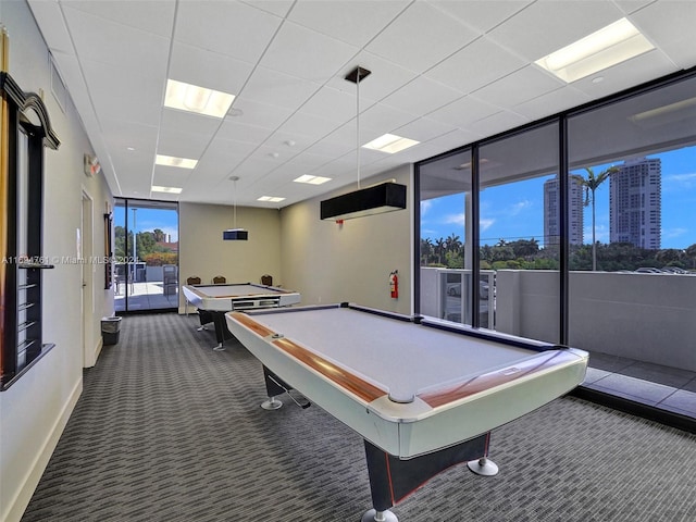 game room with dark colored carpet, expansive windows, and billiards