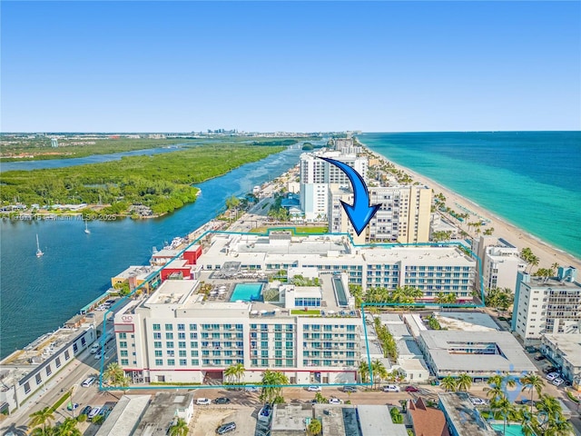 bird's eye view with a water view and a beach view