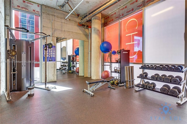 exercise room with a high ceiling