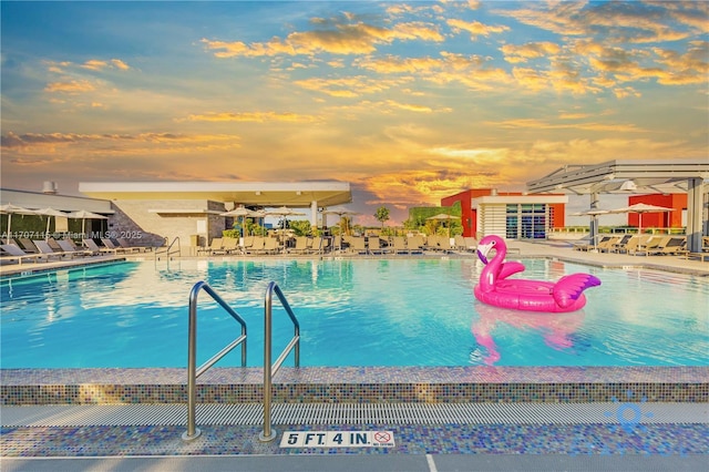 pool at dusk with a patio