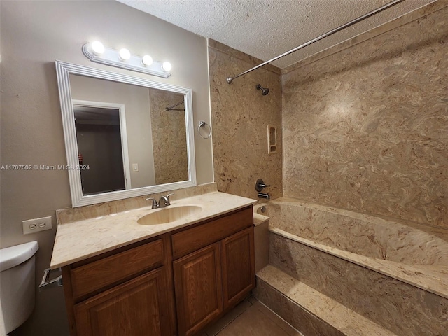 full bathroom featuring vanity, tile patterned flooring, tiled shower / bath combo, toilet, and a textured ceiling