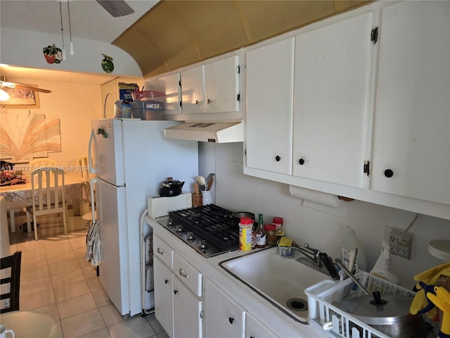 kitchen with white cabinetry, sink, light tile patterned floors, and exhaust hood