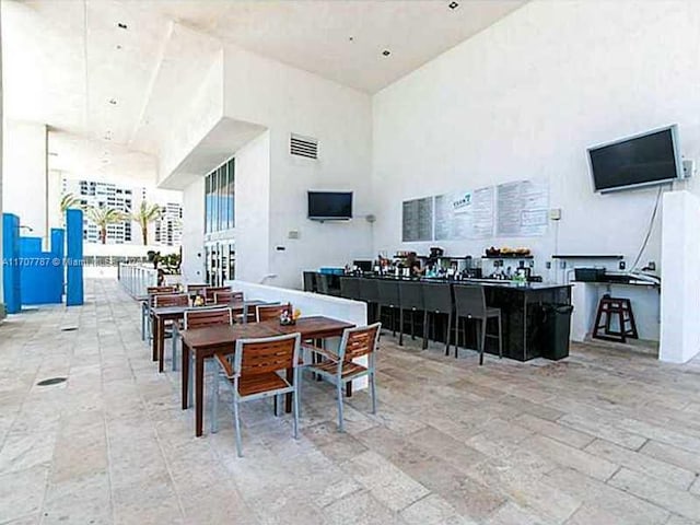 dining room featuring a towering ceiling